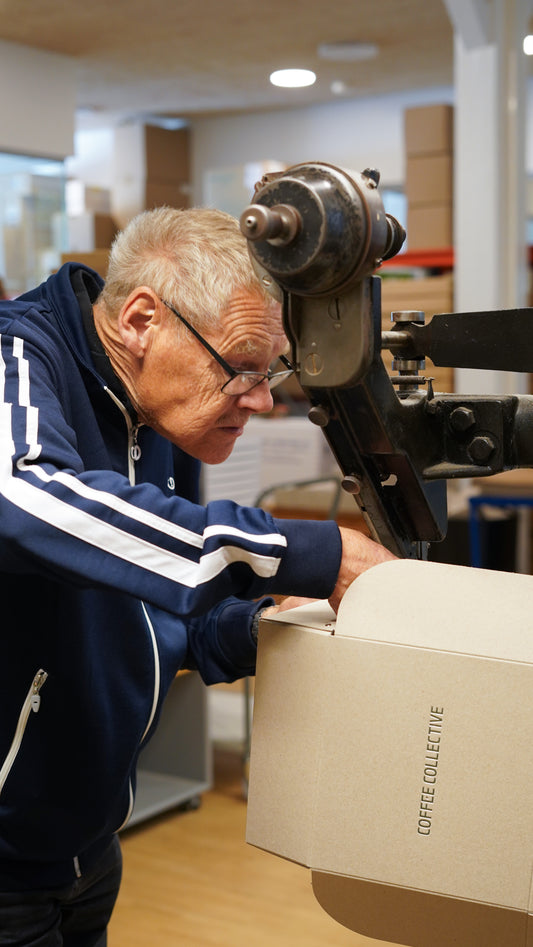 Man operating a machine in a warehouse setting